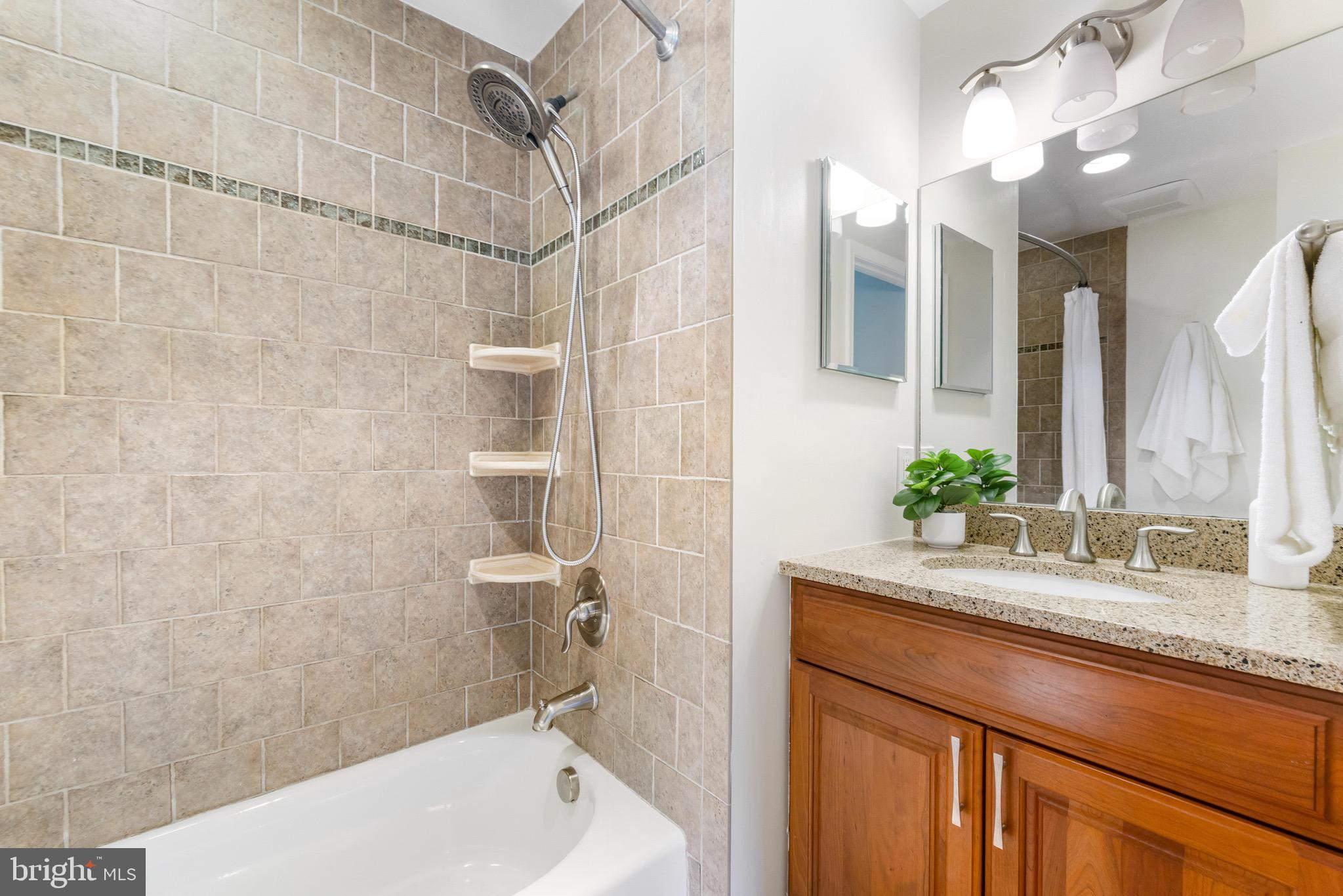 8735 Doves Fly Way Laurel, MD 20723 - Photo 41 of 64 a bathroom with a granite countertop sink a toilet and shower