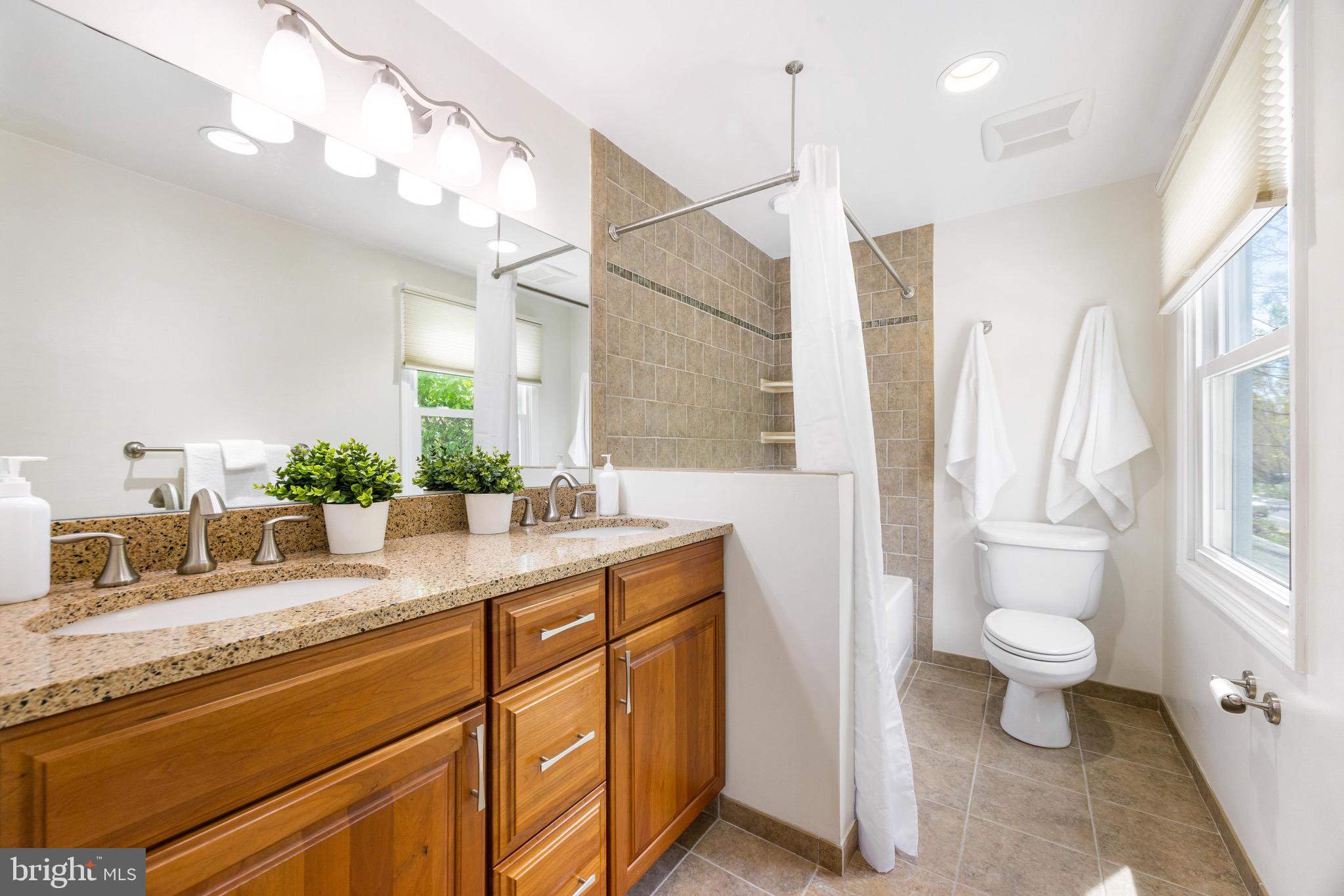 8735 Doves Fly Way Laurel, MD 20723 - Photo 46 of 64 a bathroom with a granite countertop sink a toilet and a mirror