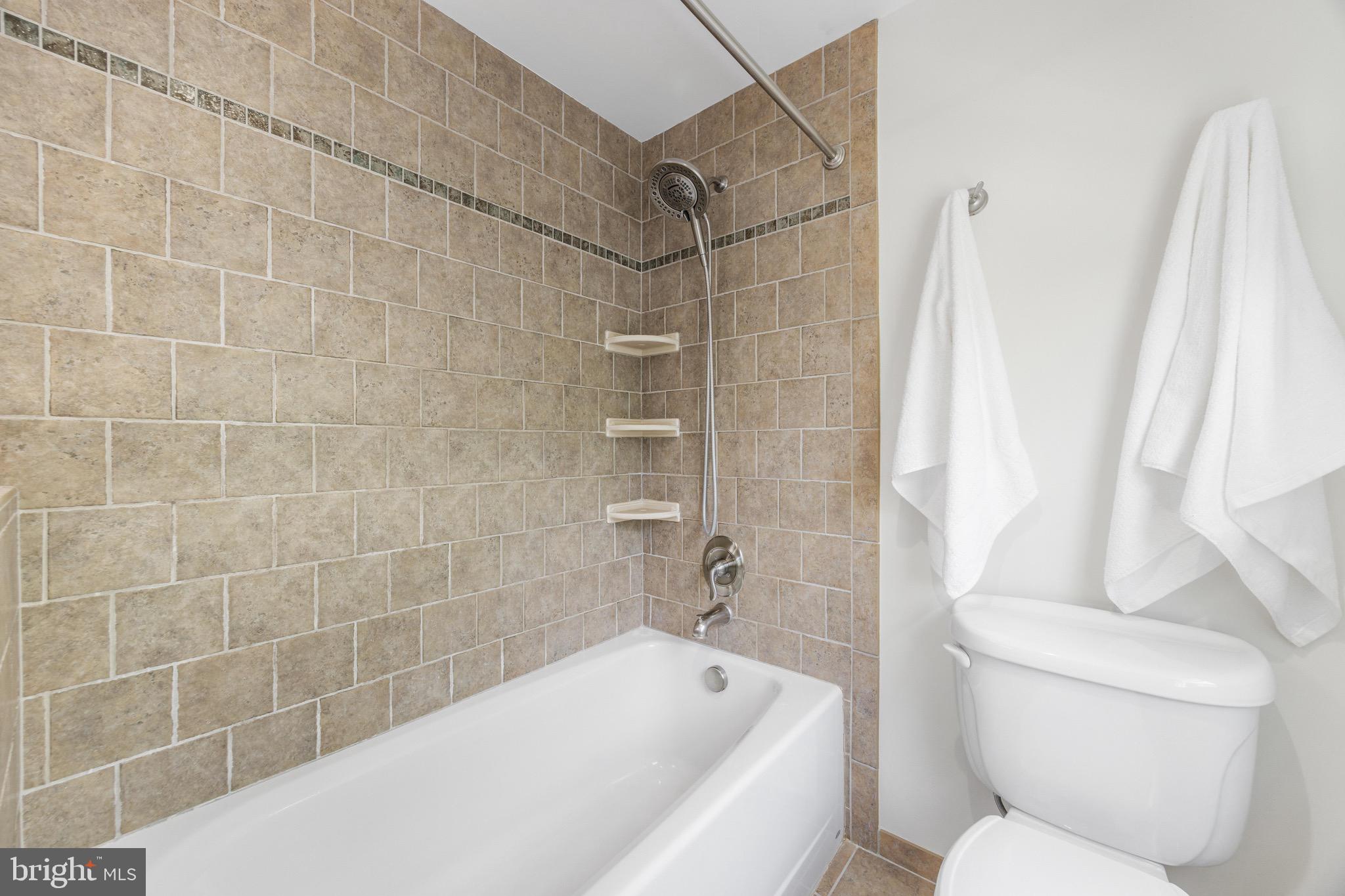 8735 Doves Fly Way Laurel, MD 20723 - Photo 47 of 64 a bathroom with a toilet and shower