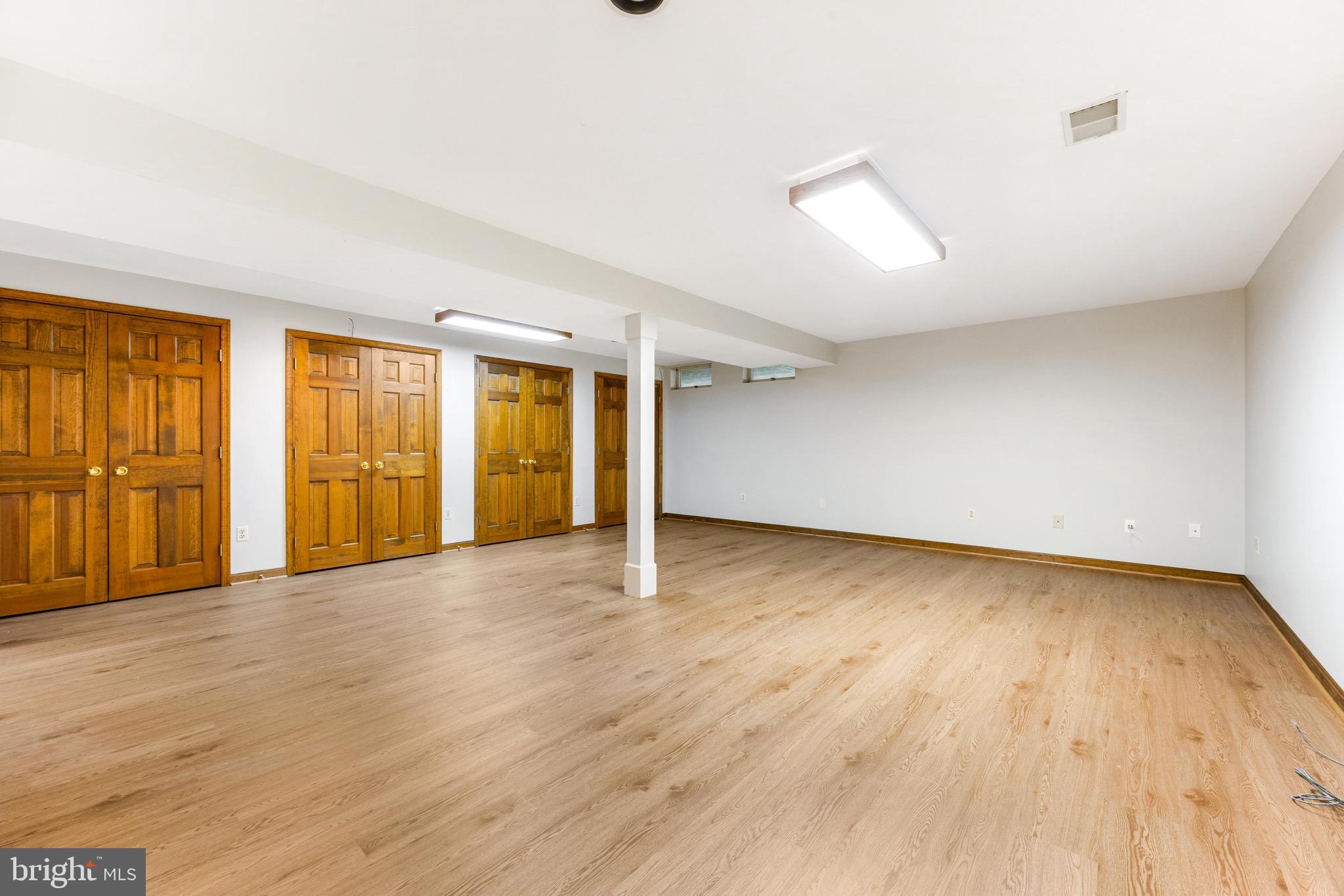 8735 Doves Fly Way Laurel, MD 20723 - Photo 54 of 64 an empty room with wooden floor and windows