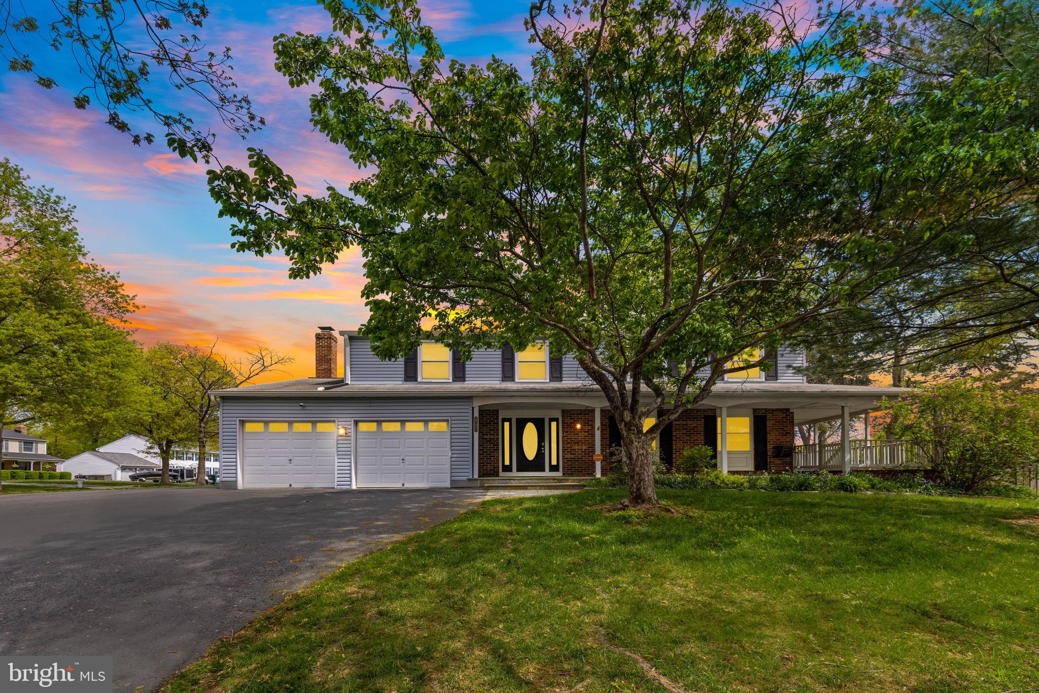8735 Doves Fly Way Laurel, MD 20723 - Photo 6 of 64 a view of a brick house next to a yard with big trees