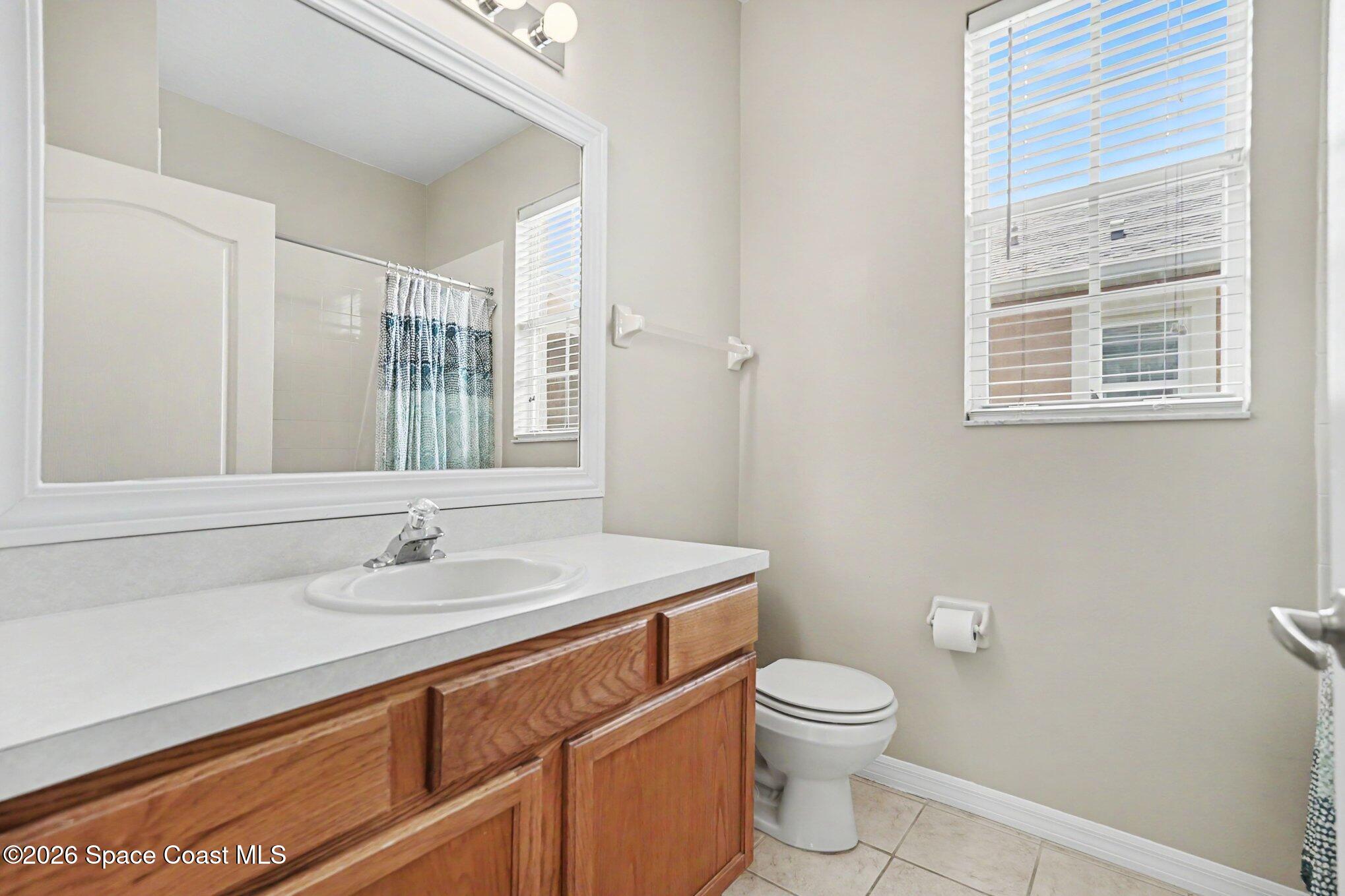 284 Intrepid Way Indialantic, FL 32903 - Photo 26 of 36 a bathroom with a sink a toilet and a mirror