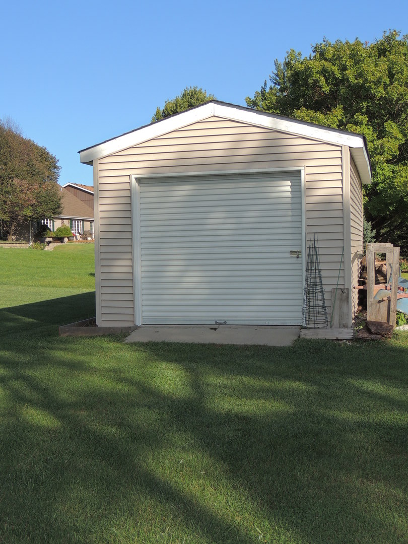 212 San Carlos Road Minooka, IL 60447 - Photo 22 of 24 a front view of a house with a yard