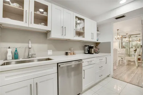 a kitchen with white cabinets and white appliances
