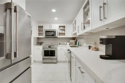 a kitchen with a sink stove and refrigerator