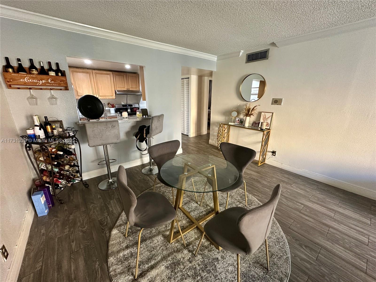 17911 Northwest 68th Avenue, Unit M106 Hialeah, FL 33015 - Photo 11 of 43 a living room with furniture and wooden floor