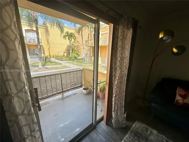 a view of an empty room and floor to ceiling window