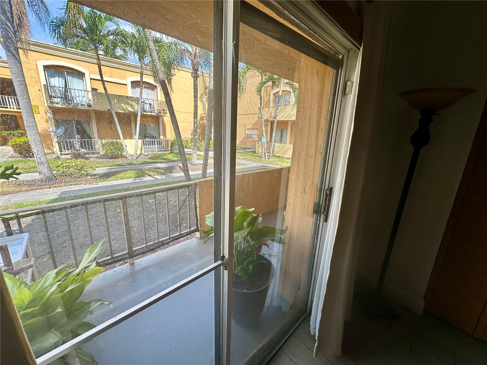17911 Northwest 68th Avenue, Unit M106 Hialeah, FL 33015 - Photo 20 of 43 a view of a glass door