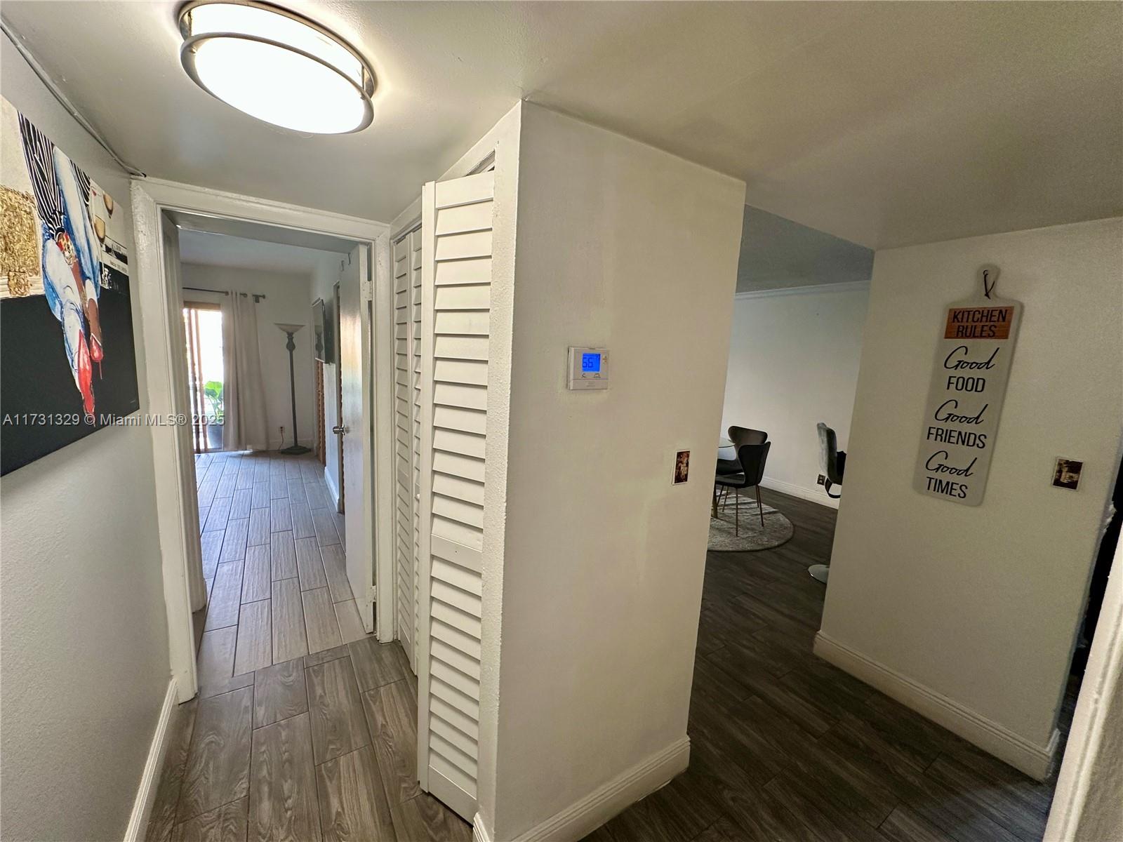 17911 Northwest 68th Avenue, Unit M106 Hialeah, FL 33015 - Photo 21 of 43 a view of a hallway with wooden floor and staircase