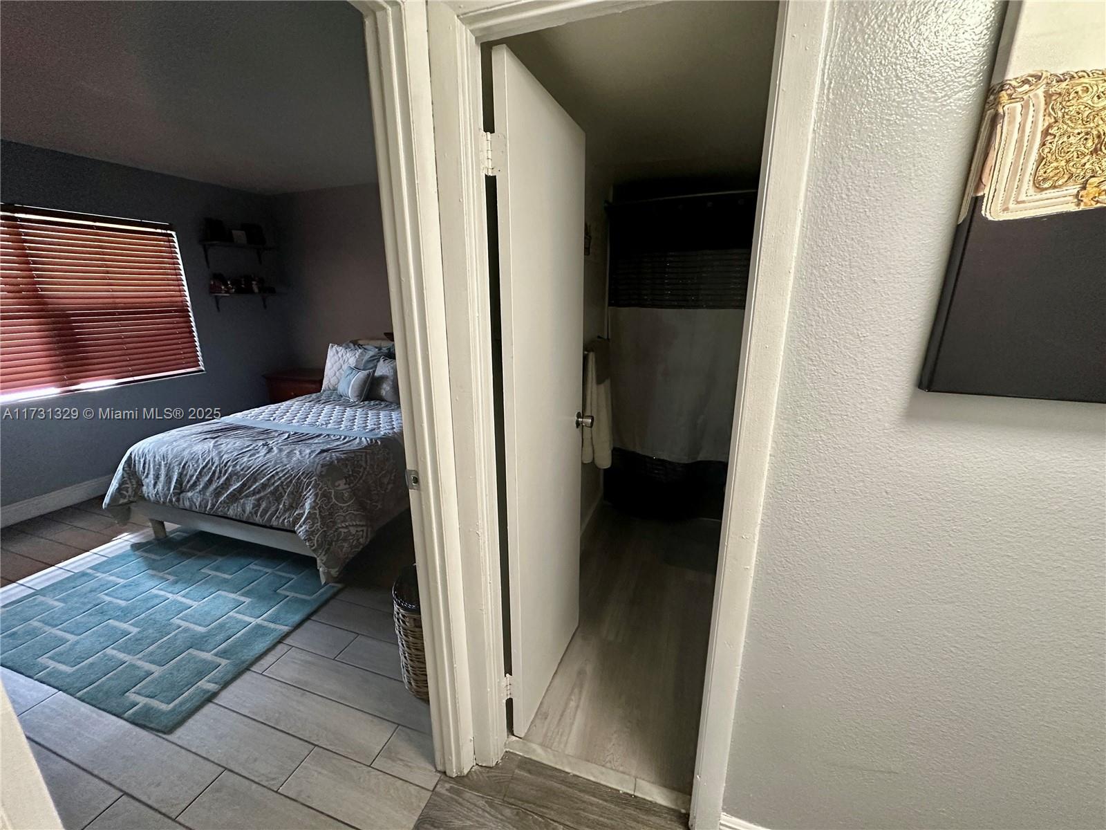 17911 Northwest 68th Avenue, Unit M106 Hialeah, FL 33015 - Photo 22 of 43 a view of a bedroom from a hallway