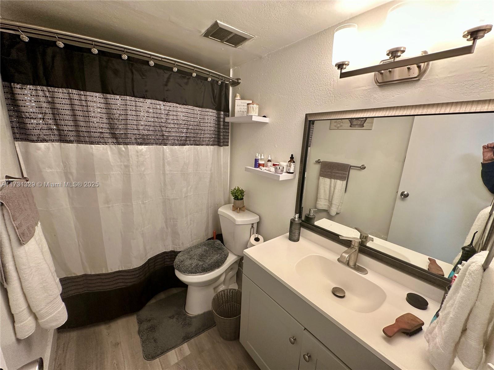 17911 Northwest 68th Avenue, Unit M106 Hialeah, FL 33015 - Photo 24 of 43 a bathroom with a sink toilet and shower