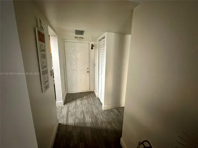 a view of a workspace with furniture and wooden floor