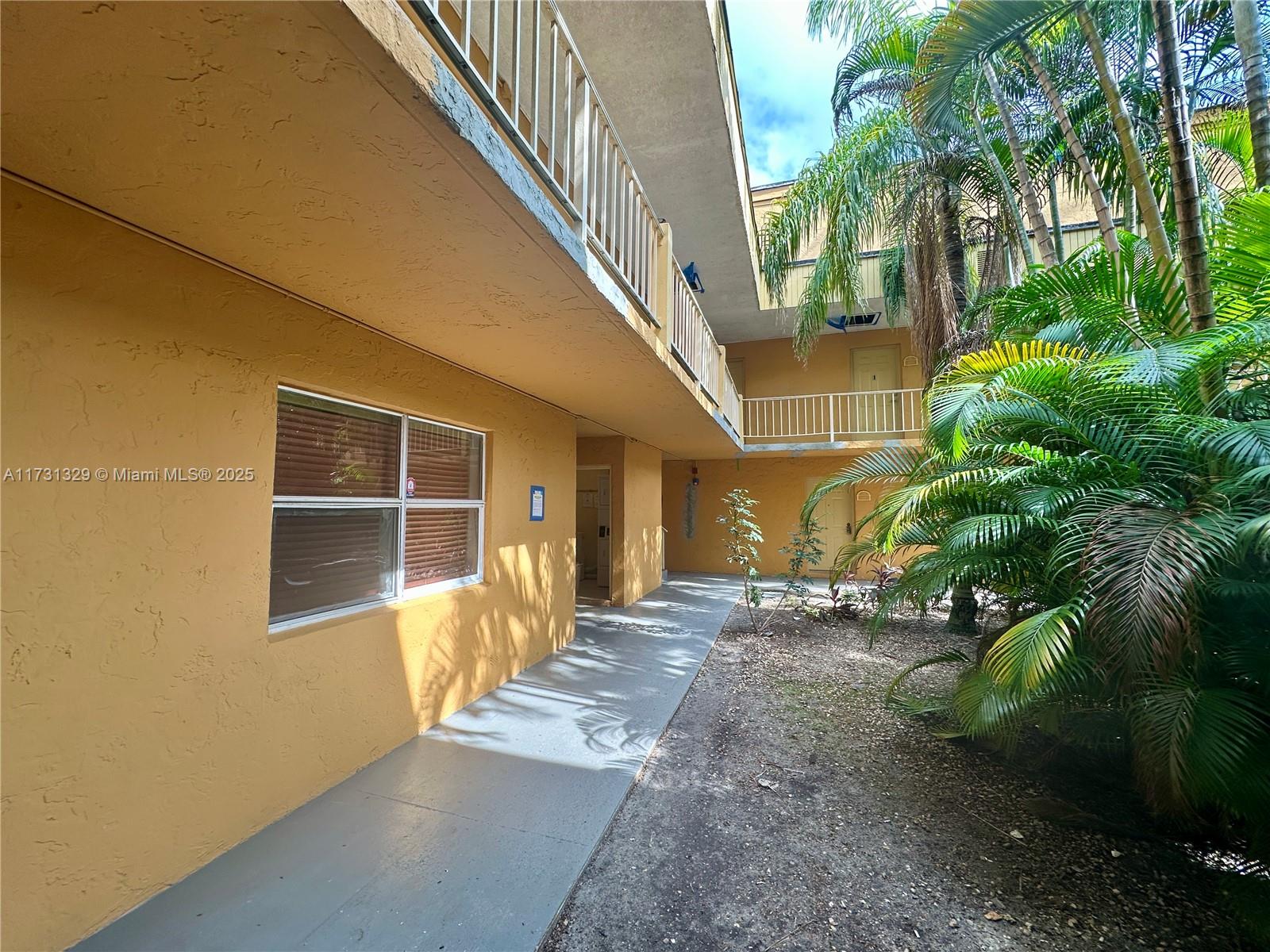 17911 Northwest 68th Avenue, Unit M106 Hialeah, FL 33015 - Photo 28 of 43 a view of a house with a yard
