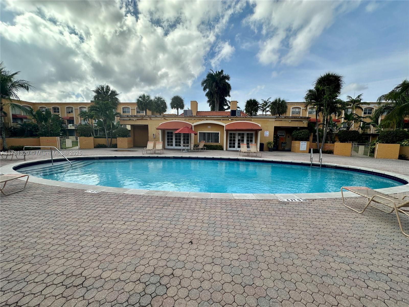 17911 Northwest 68th Avenue, Unit M106 Hialeah, FL 33015 - Photo 35 of 43 a view of a lake with building in front of it