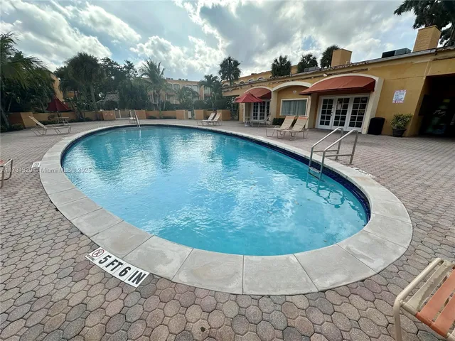 a view of a house with swimming pool and sitting area