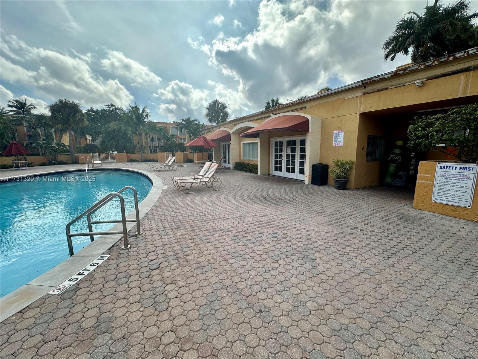 17911 Northwest 68th Avenue, Unit M106 Hialeah, FL 33015 - Photo 38 of 43 a view of a house with swimming pool and sitting area
