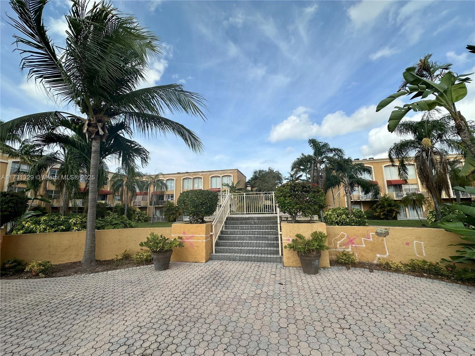 17911 Northwest 68th Avenue, Unit M106 Hialeah, FL 33015 - Photo 39 of 43 a view of a yard with potted plants