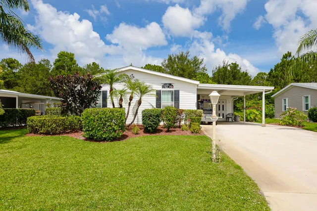 a front view of a house with a yard and porch