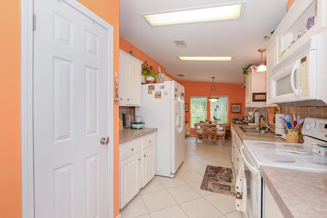 a view of washer and dryer with bathroom in the background