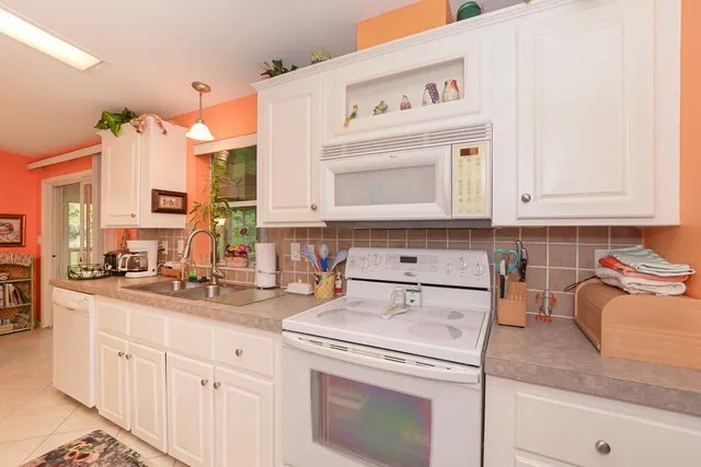 a living room with furniture a rug and a window