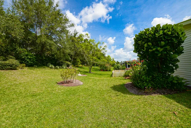 a living room with furniture a flat screen tv and a large window
