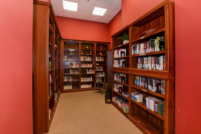 a view of a lake with a yard and large trees