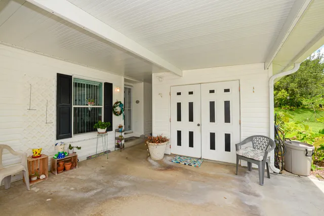 a bedroom with pink walls and chandelier