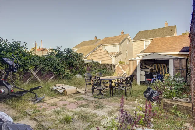 a backyard of a house with table and chairs