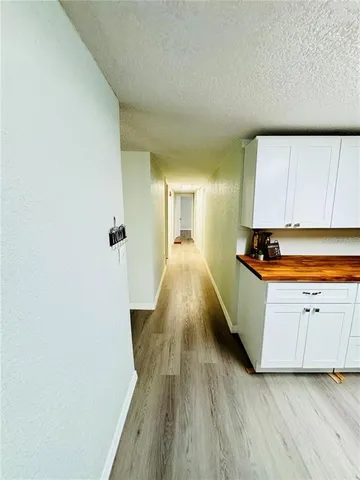 a view of a kitchen with wooden floor