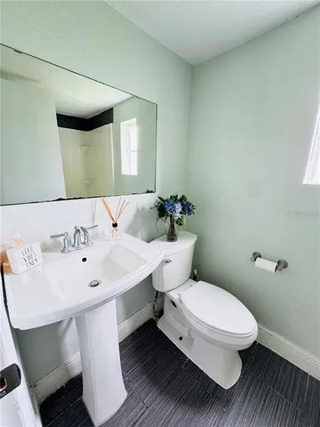 a white toilet sitting next to a bathroom sink