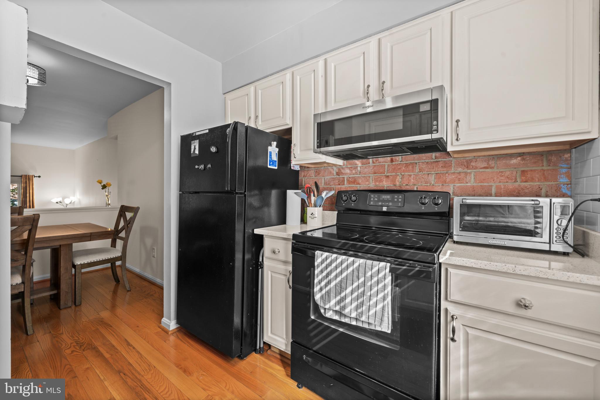 5824 Rexford Drive, Unit 731 Springfield, VA 22152 - Photo 11 of 30 a kitchen with granite countertop a refrigerator stove and microwave
