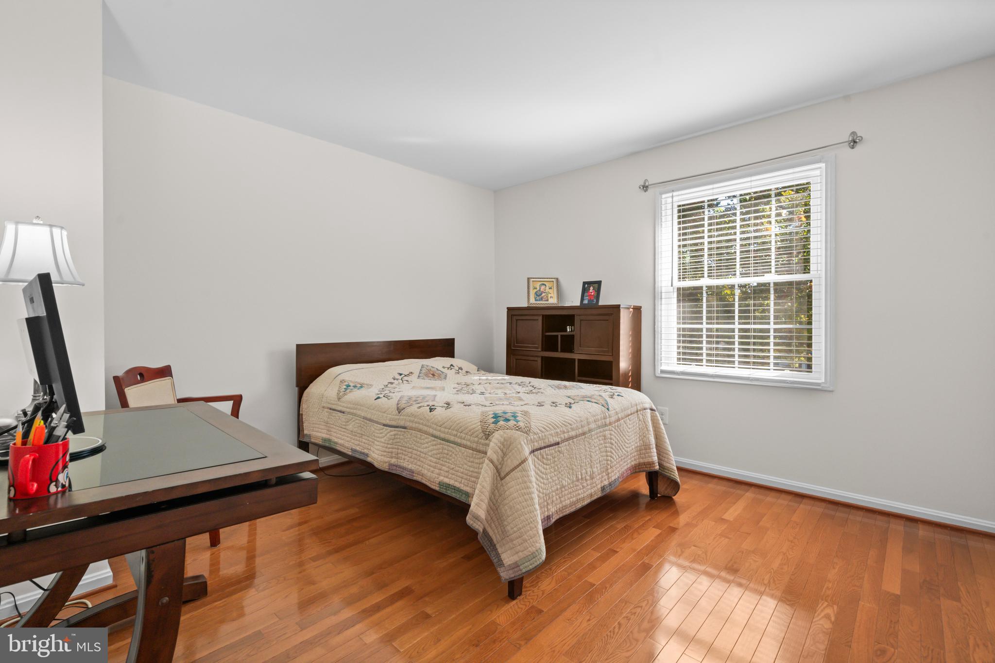 5824 Rexford Drive, Unit 731 Springfield, VA 22152 - Photo 19 of 30 a bedroom with a bed and a flat tv screen on a dresser