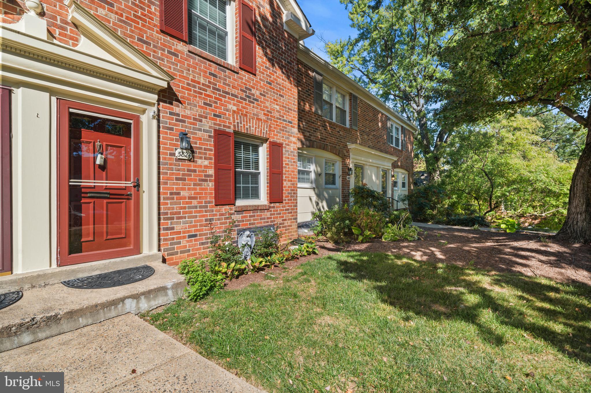 5824 Rexford Drive, Unit 731 Springfield, VA 22152 - Photo 25 of 30 a view of a brick house with a yard plants and large tree