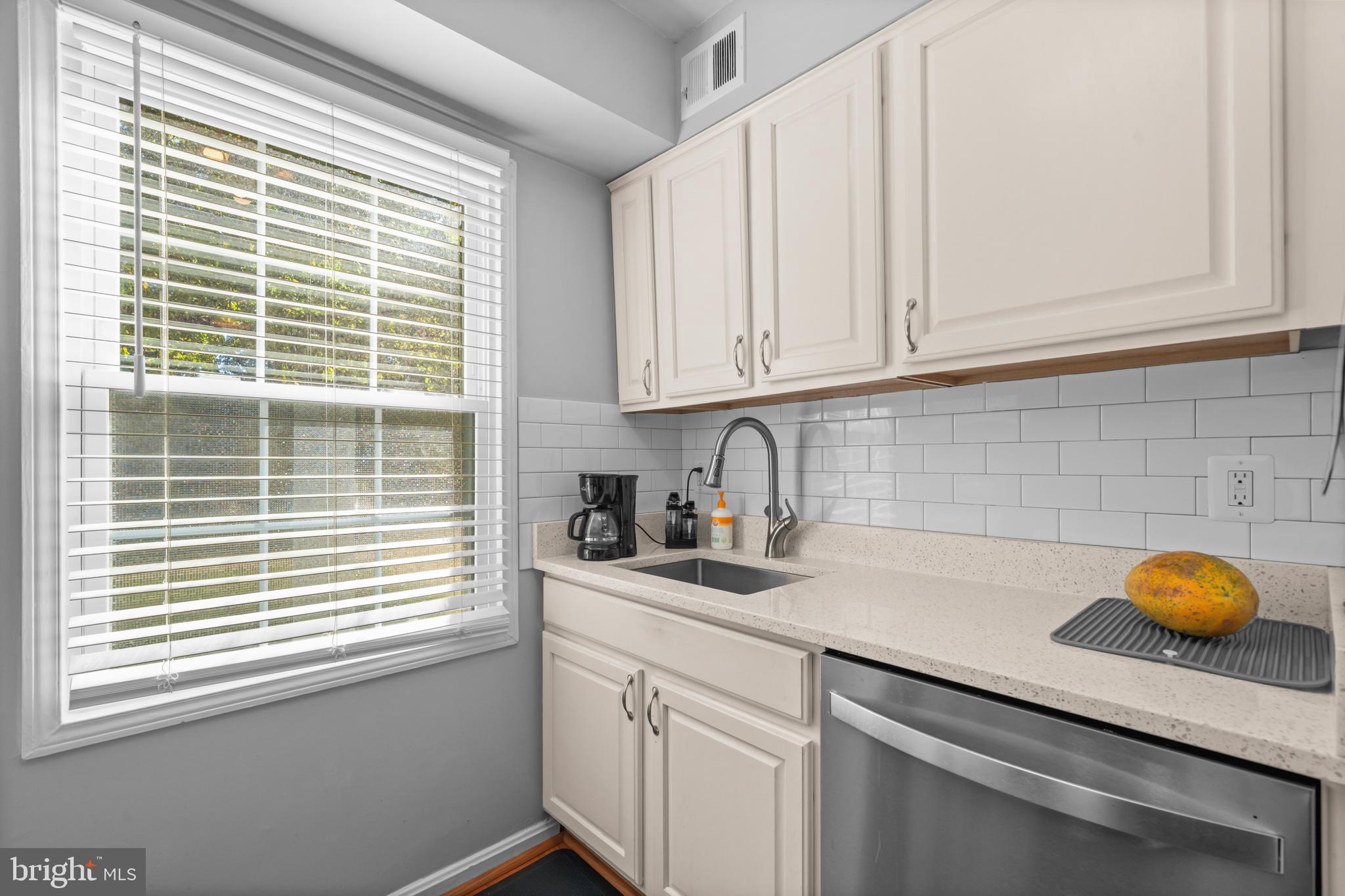 5824 Rexford Drive, Unit 731 Springfield, VA 22152 - Photo 10 of 30 a kitchen with stainless steel appliances granite countertop white cabinets and a window