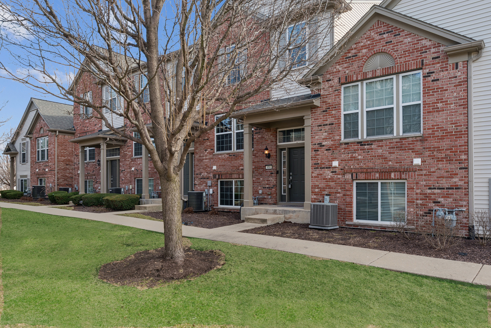 464 Valentine Way Oswego, IL 60543 - Photo 1 of 30 a front view of a house with a garden and trees