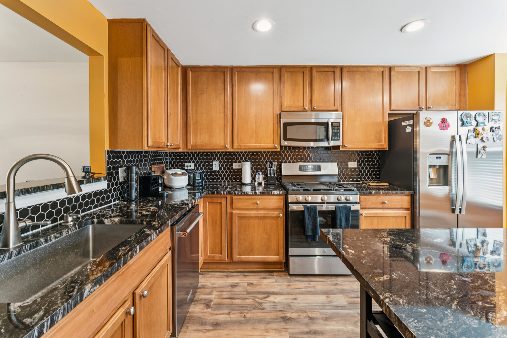 464 Valentine Way Oswego, IL 60543 - Photo 11 of 30 a kitchen with stainless steel appliances granite countertop a stove a sink dishwasher a refrigerator and a microwave