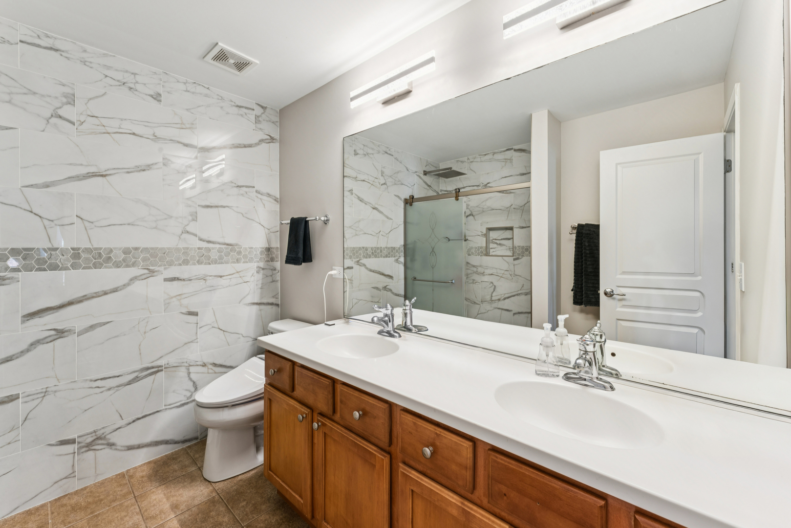 464 Valentine Way Oswego, IL 60543 - Photo 21 of 30 a bathroom with a sink and a mirror