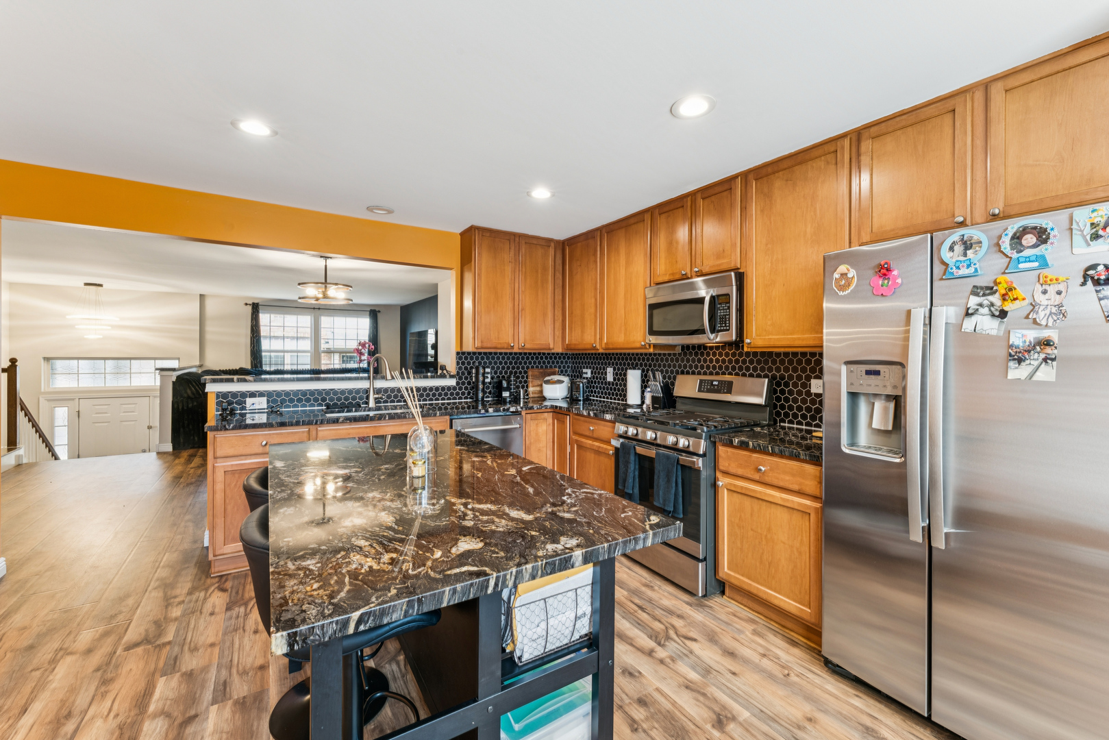 464 Valentine Way Oswego, IL 60543 - Photo 10 of 30 a kitchen with stainless steel appliances granite countertop a refrigerator a stove top oven a sink and a refrigerator