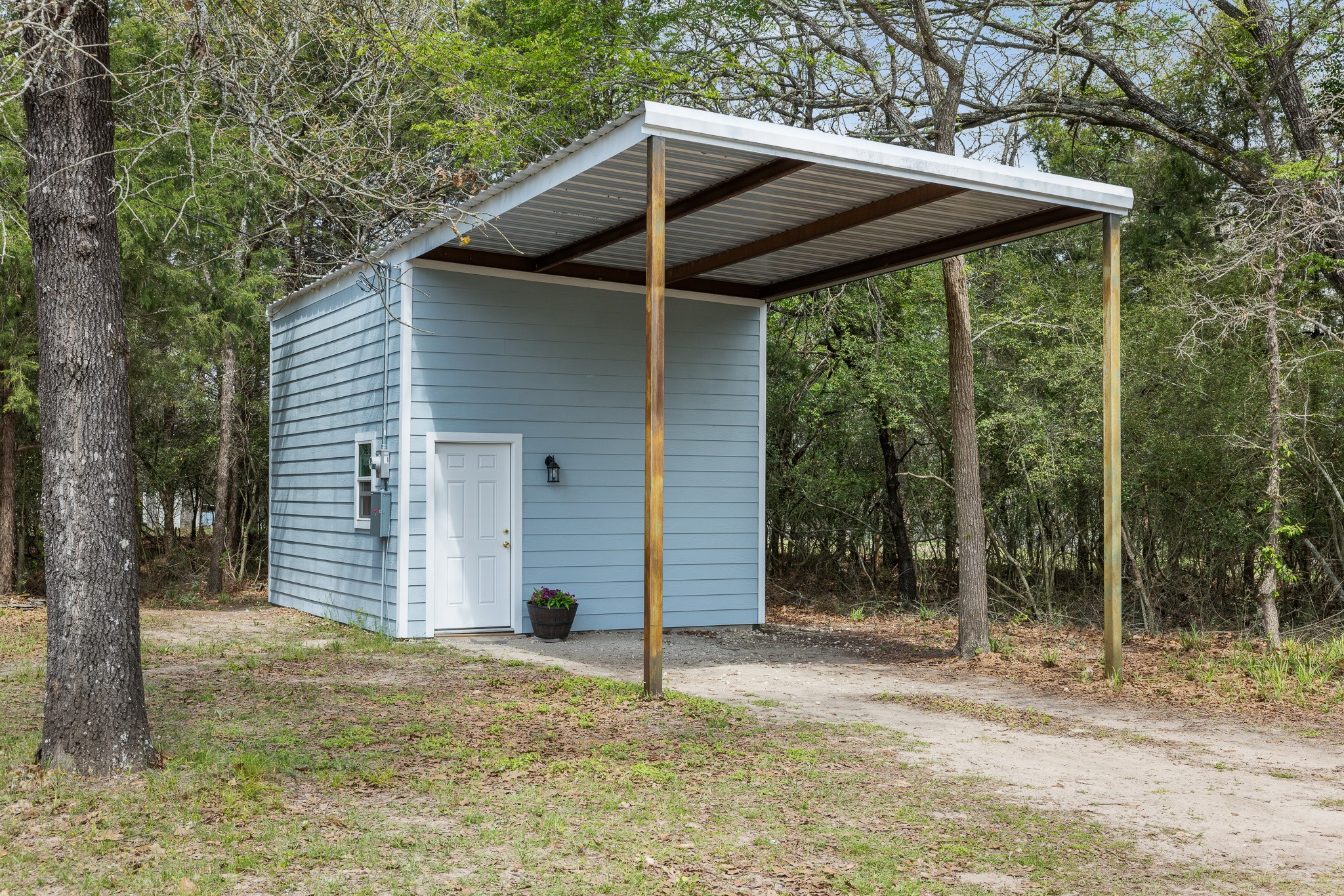 4196 Winding Road Hearne, TX 77859 - Photo 15 of 33 a backyard of a house with large trees and table and chairs