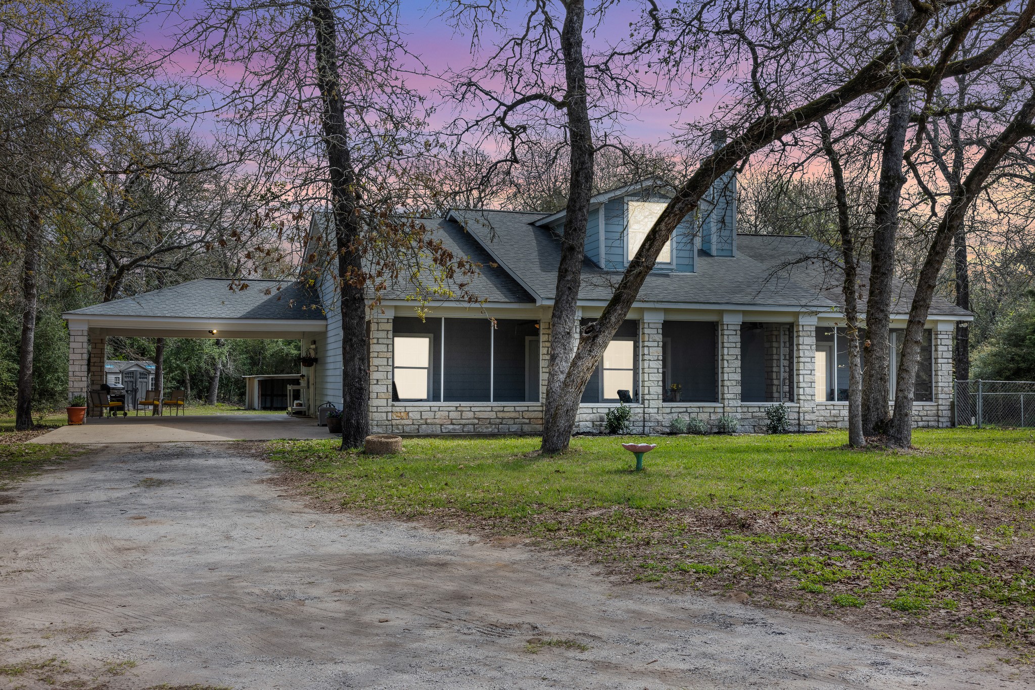 4196 Winding Road Hearne, TX 77859 - Photo 17 of 33 a front view of a house with a garden and trees