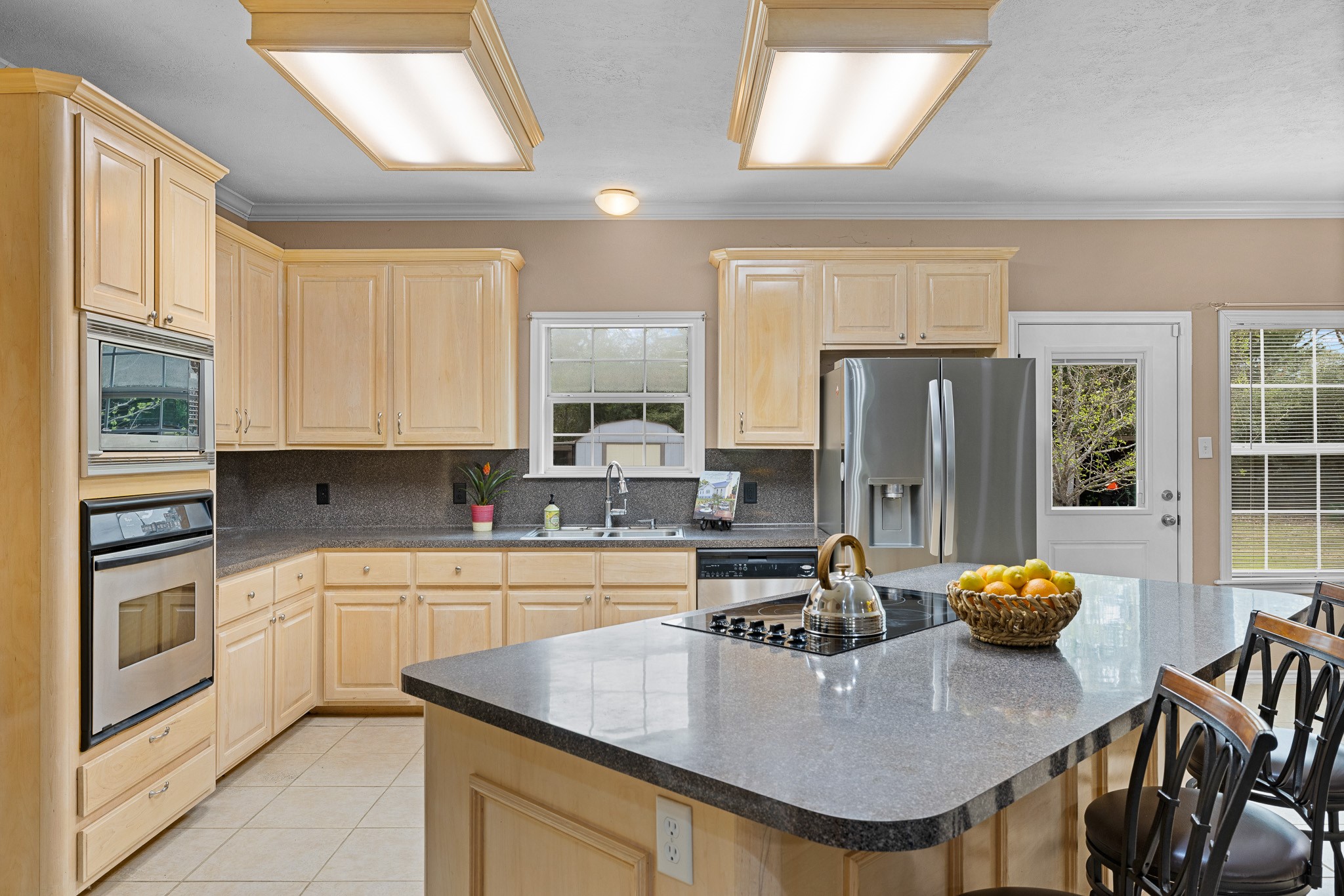 4196 Winding Road Hearne, TX 77859 - Photo 5 of 33 a kitchen with stainless steel appliances granite countertop a kitchen island a stove a table and chairs