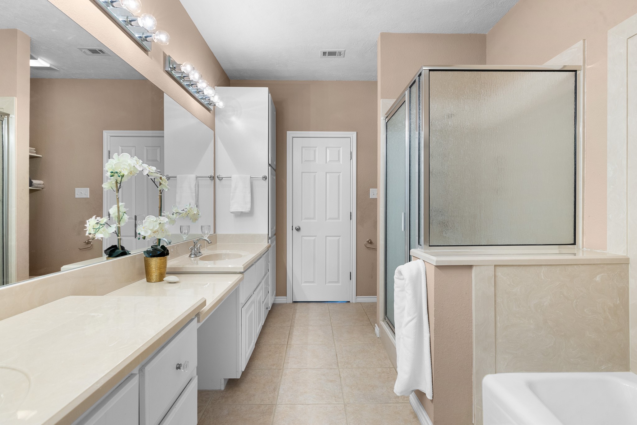 4196 Winding Road Hearne, TX 77859 - Photo 9 of 33 a bathroom with a double vanity sink and mirror with shower