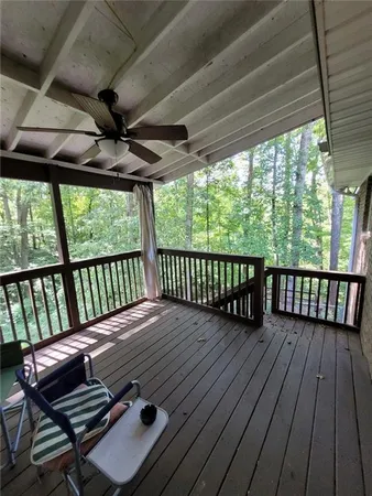 a view of a wooden deck with a table and chairs