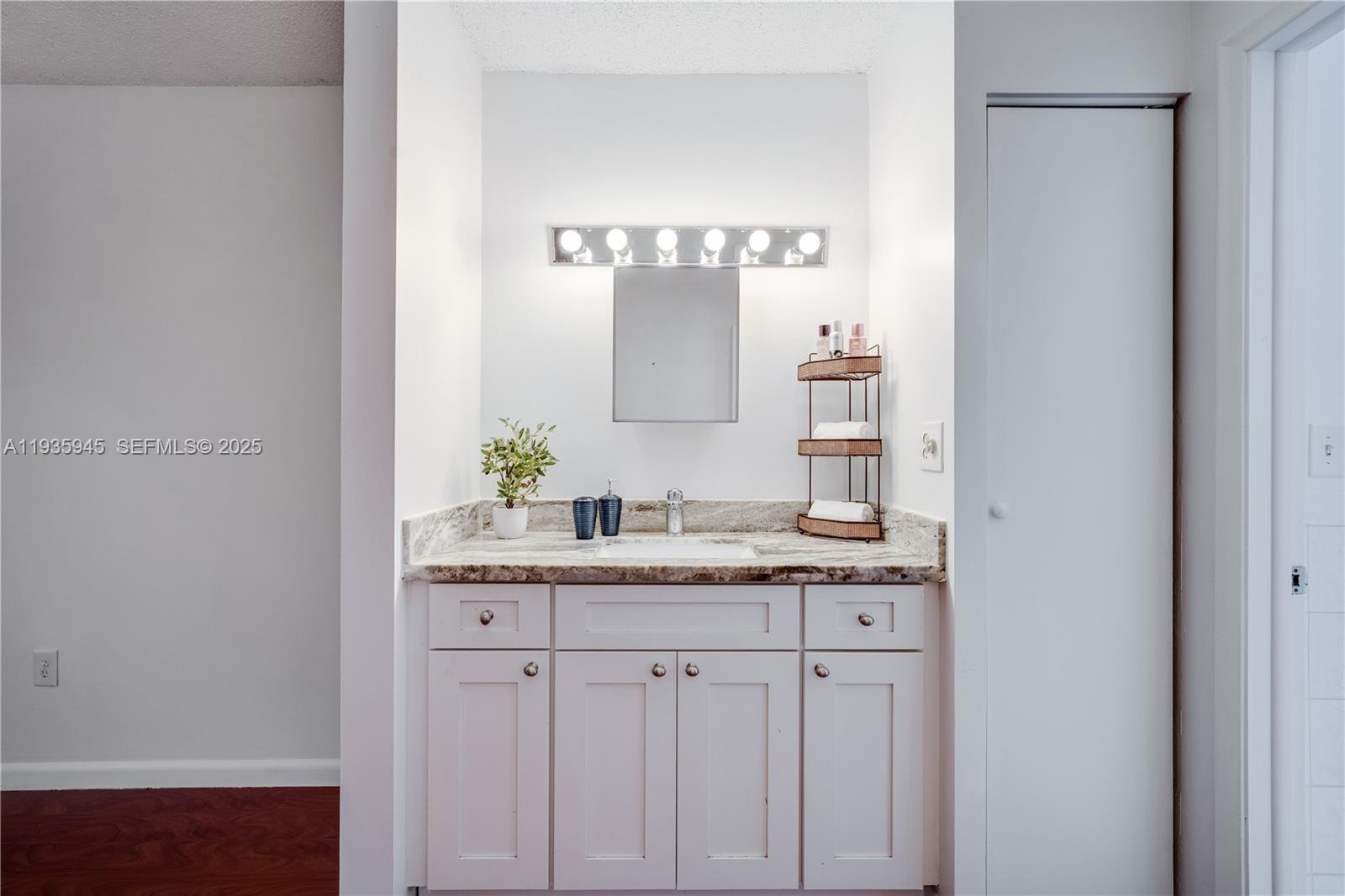 11483 Southwest 109th Road, Unit 2E Miami, FL 33176 - Photo 23 of 45 a bathroom with a granite countertop sink and a mirror