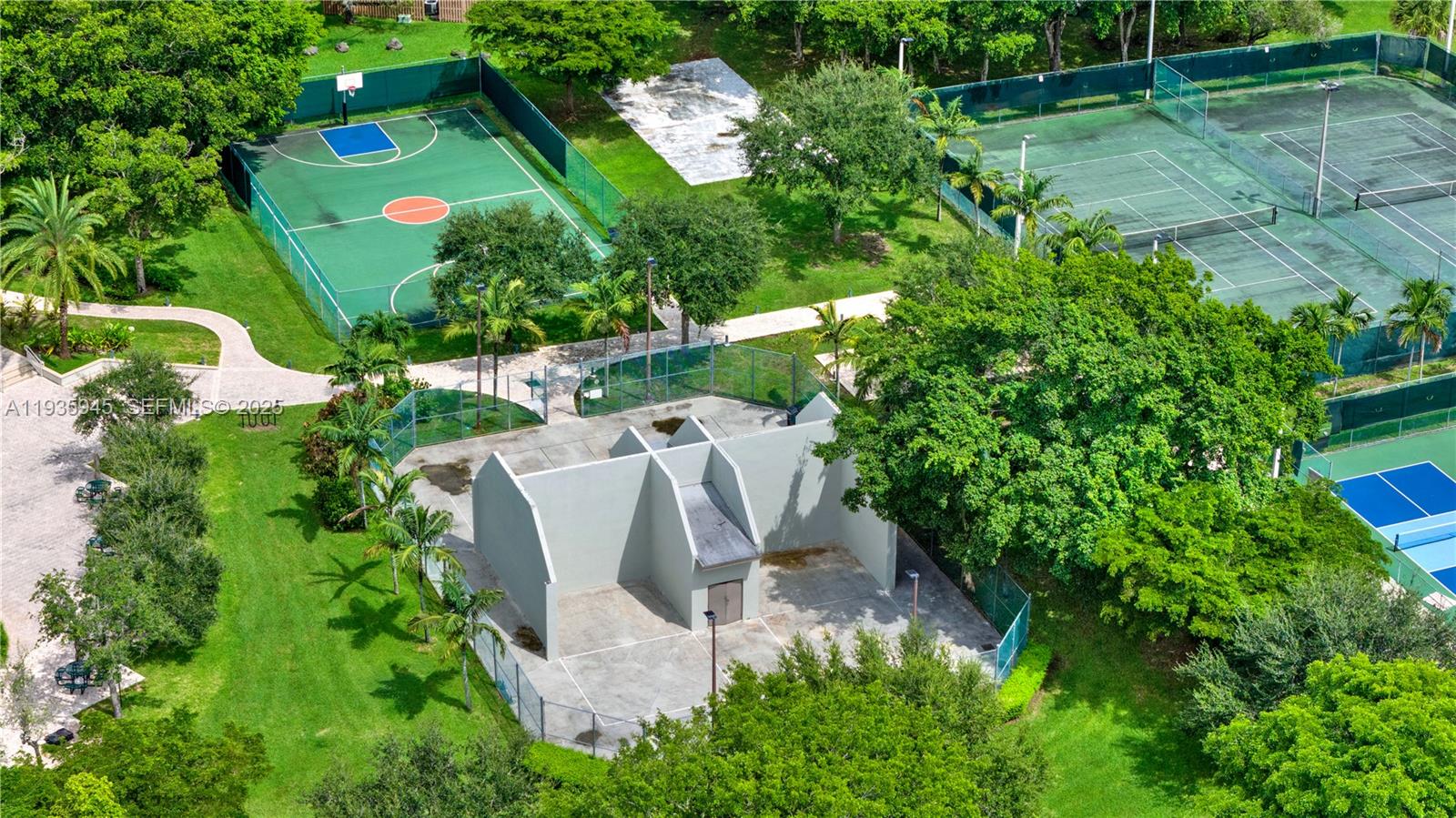 11483 Southwest 109th Road, Unit 2E Miami, FL 33176 - Photo 31 of 45 an aerial view of a house with a yard and large trees