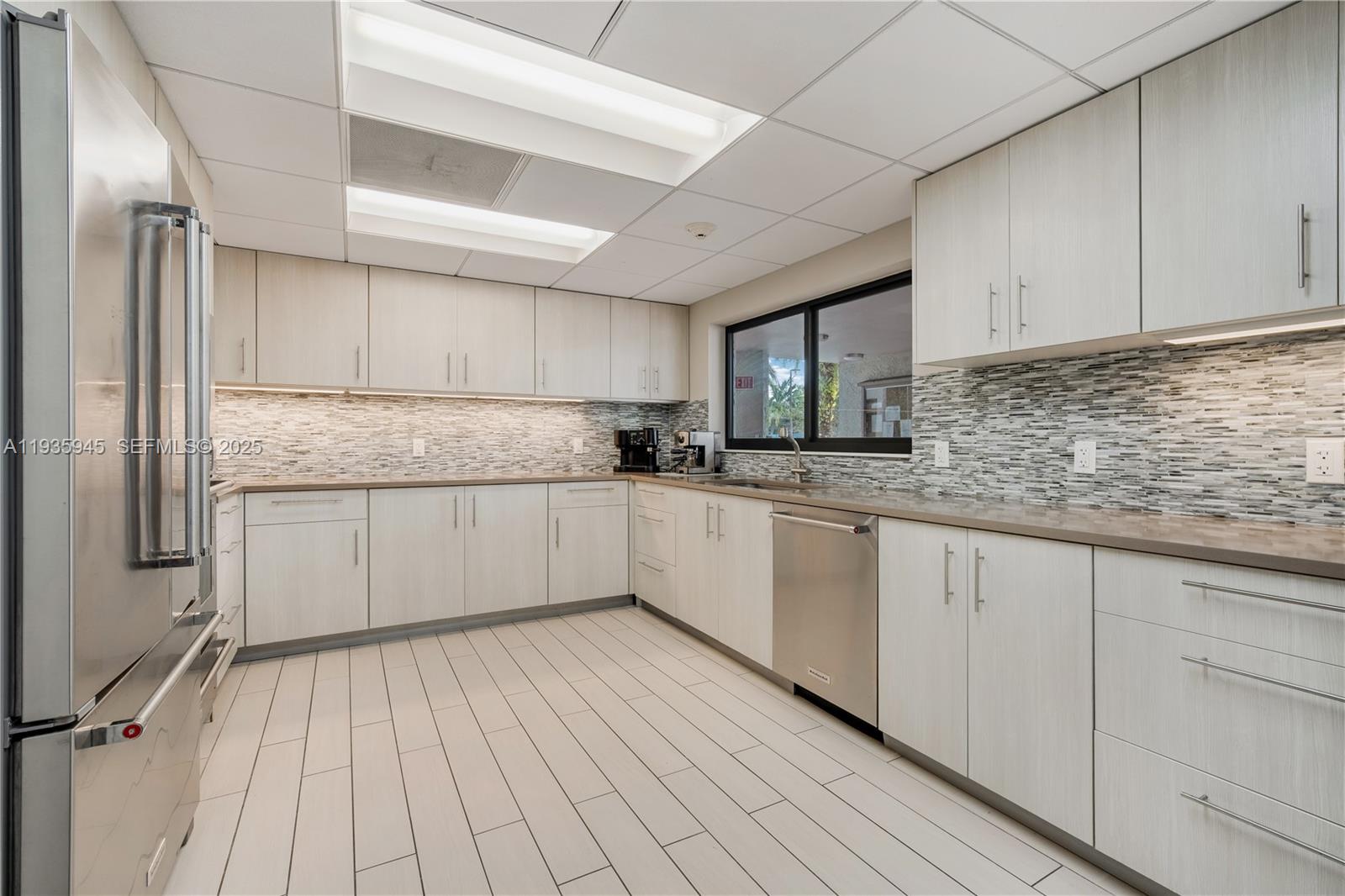 11483 Southwest 109th Road, Unit 2E Miami, FL 33176 - Photo 39 of 45 a kitchen with granite countertop white cabinets and white stainless steel appliances