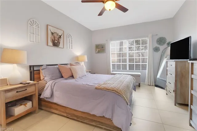 a bedroom with bed and a flat tv screen