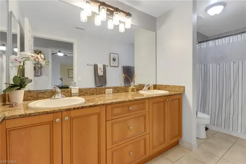 a bathroom with a double vanity sink and a mirror