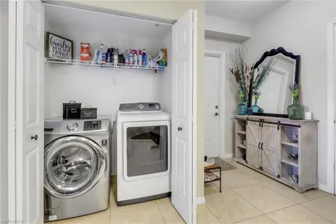 a utility room with closet dryer and washer