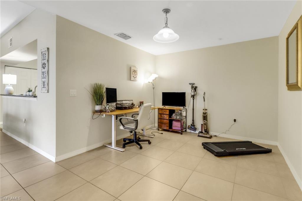 20221 Estero Gardens Circle, Unit 104 Estero, FL 33928 - Photo 20 of 43 a view of a workspace with furniture and a window
